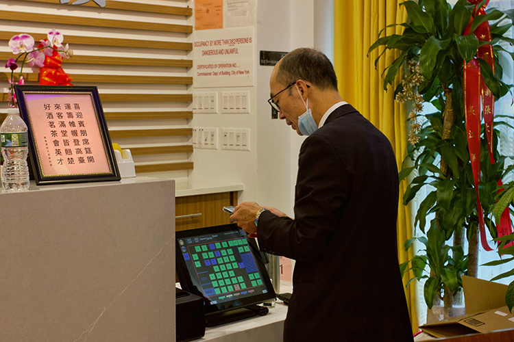 the manager standing in front of an ordering machine